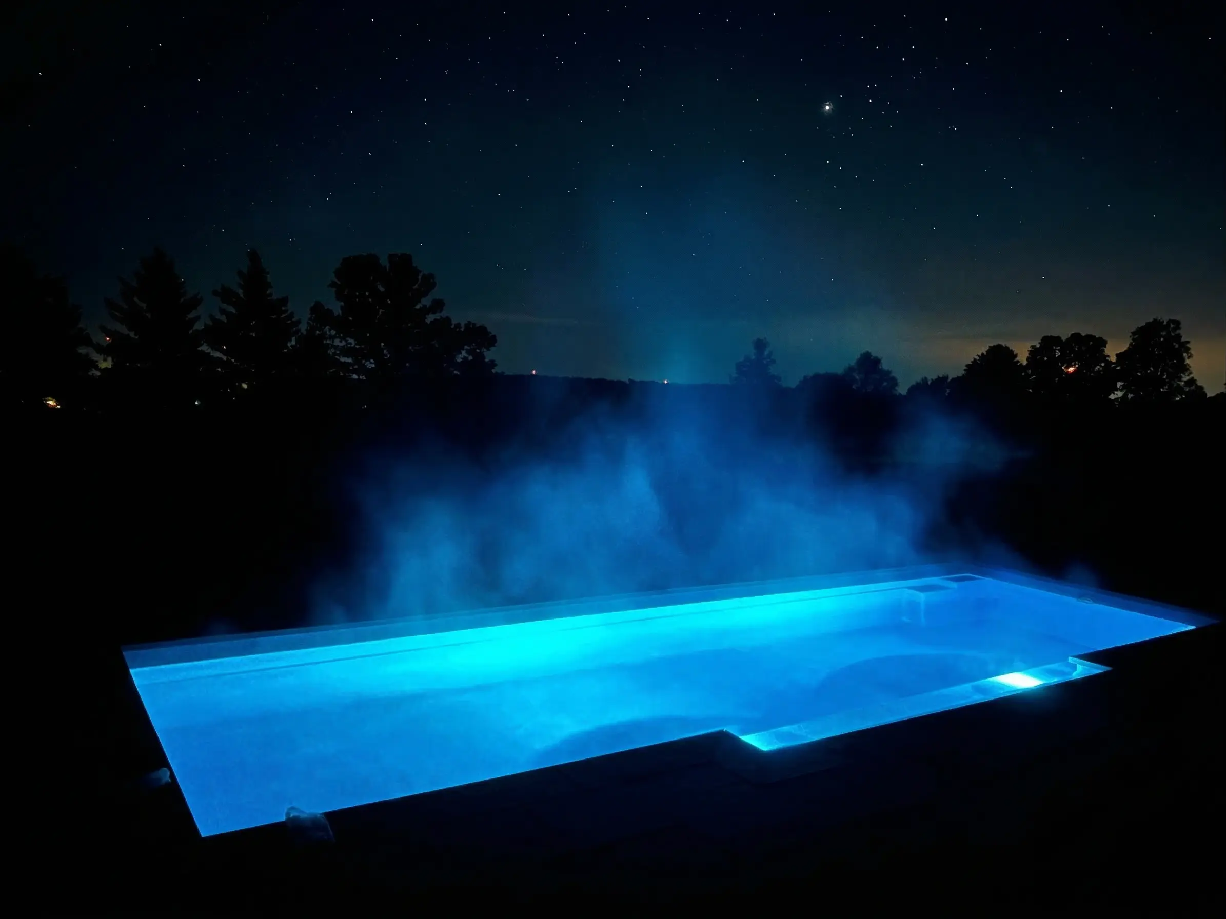 Pool with blue underwater lights at night